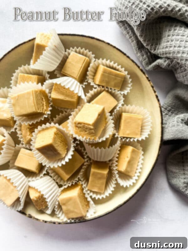Decadent Peanut Butter Fudge 14 A cutting board filled with peanut butter fudge squares.