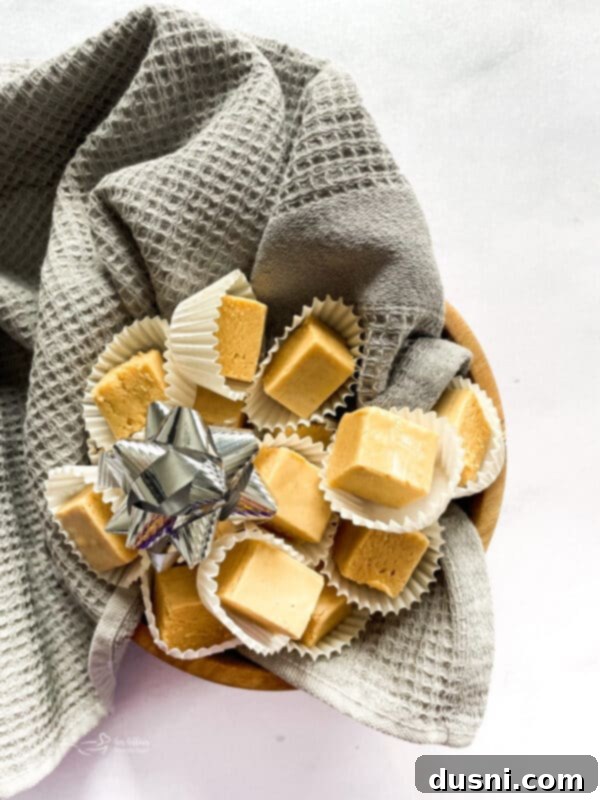 Decadent Peanut Butter Fudge 3 Close-up of golden peanut butter fudge squares.