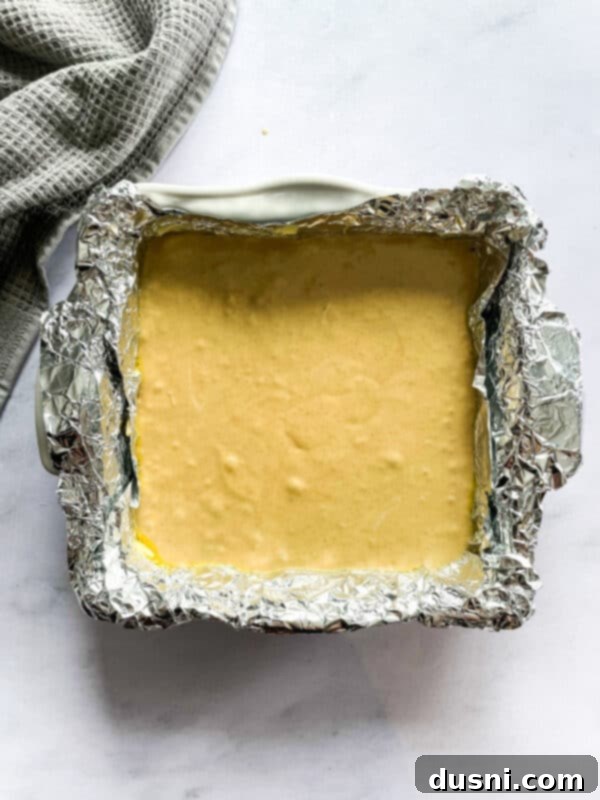 Decadent Peanut Butter Fudge 7 Adding peanut butter and marshmallow fluff to the hot sugar mixture.