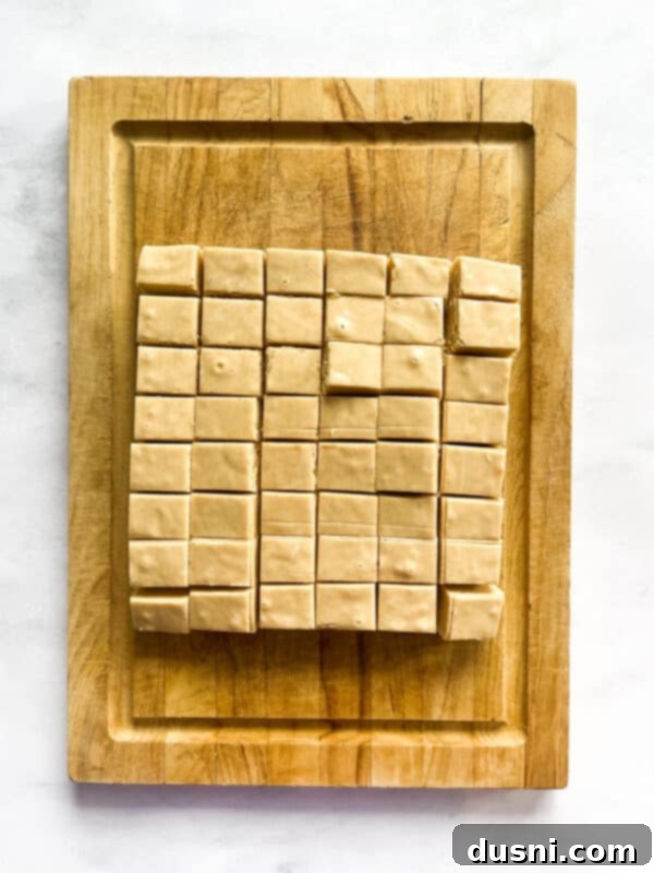 Decadent Peanut Butter Fudge 8 Firm peanut butter fudge in a foil-lined pan.