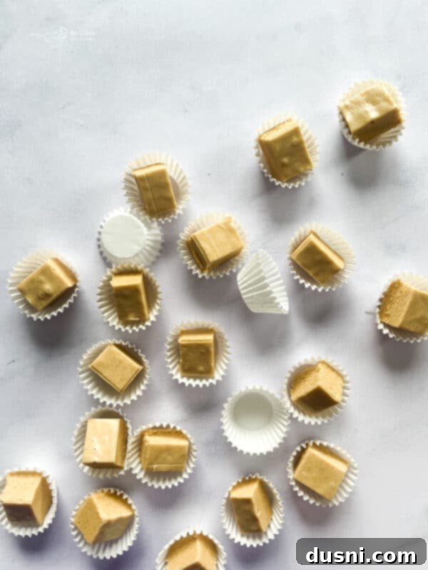 Decadent Peanut Butter Fudge 10 A large pile of peanut butter fudge squares.