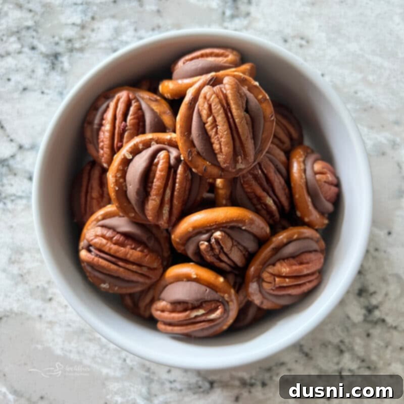 A festive bowl of Rolo Pretzel Bites with red and green M&M's for Christmas