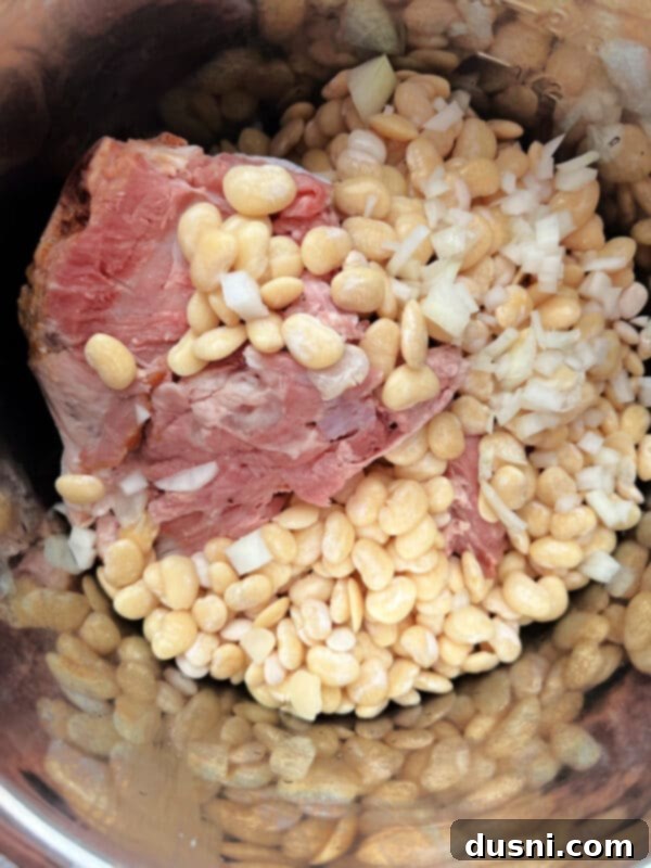 Instant Pot Grandmas Comforting Ham and Bean Soup 11 Ham bone being placed into the Instant Pot