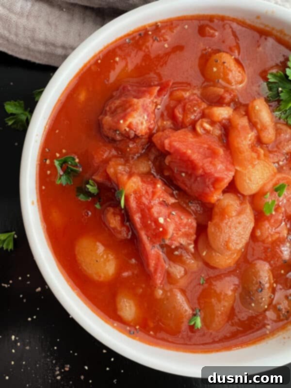 Instant Pot Grandmas Comforting Ham and Bean Soup 3 Close-up of a bowl of Instant Pot Ham and Bean Soup with a spoon