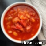 Instant Pot Grandmas Comforting Ham and Bean Soup 20 Instant Pot Ham and Bean Soup in a white bowl, garnished with parsley