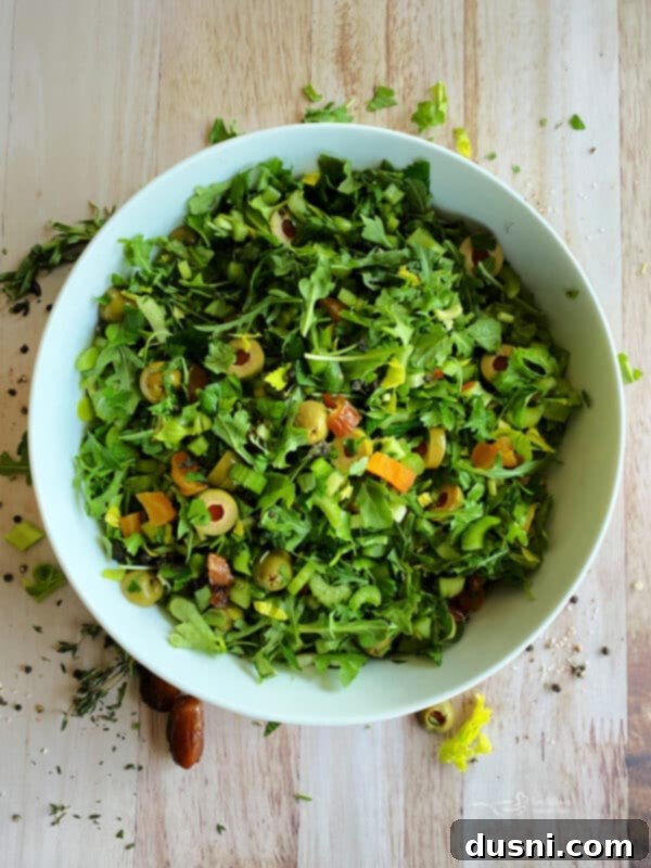 Step 3: Olives, apricots, and dates added to the salad ingredients.