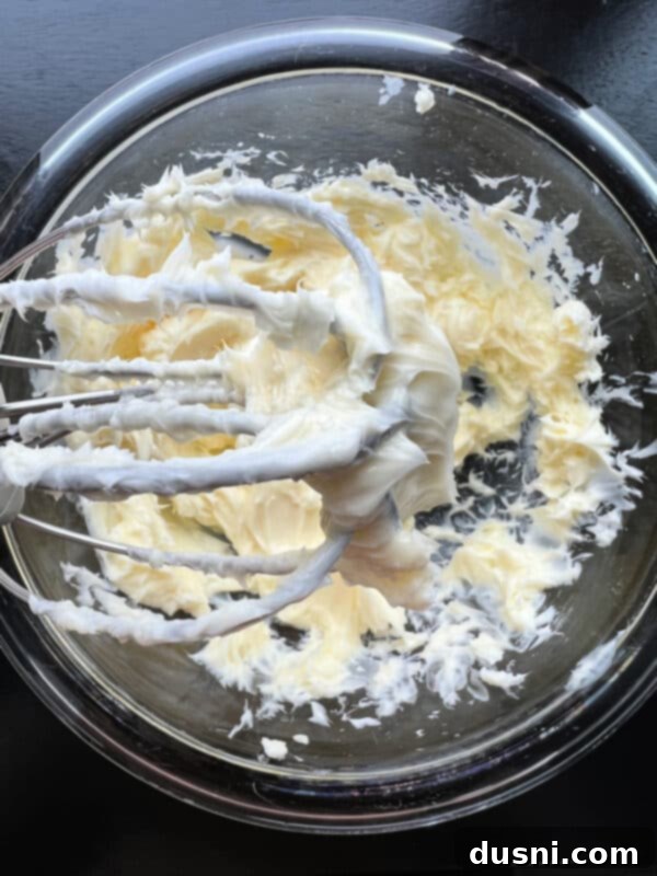 Cherry Cloud Spread 6 Close up of a hand mixer creaming softened butter in a bowl.