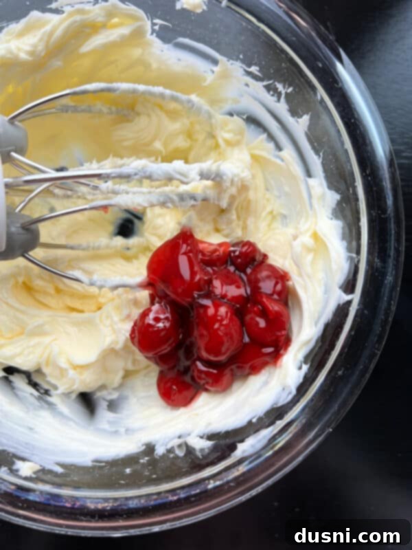 Cherry Cloud Spread 8 Beating cherry pie filling into the butter mixture.
