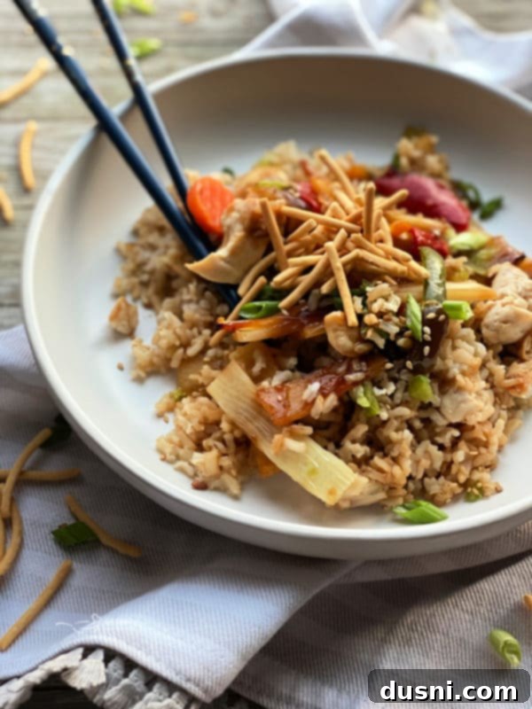 Close-up of Teriyaki Chicken Casserole with a spoon serving a portion