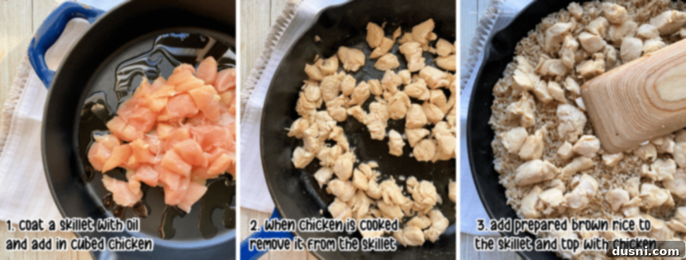 Cubed chicken cooking in sesame oil in a cast iron skillet