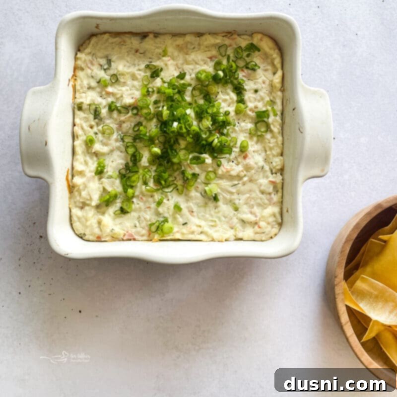 Savory Crab Rangoon Dip 9 The Crab Rangoon Dip baking in the oven, looking hot and bubbly around the edges.