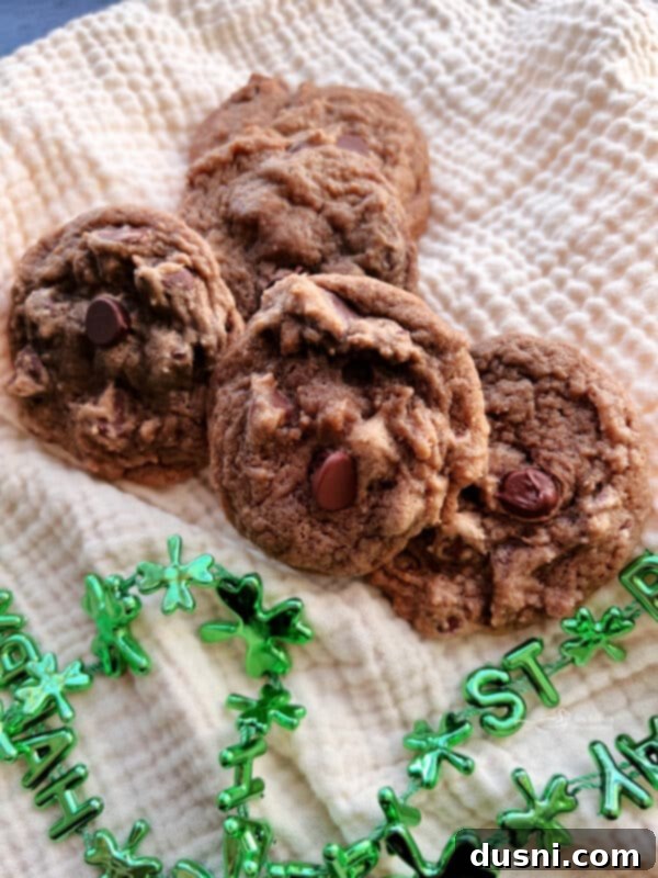 Freshly baked Bailey's Chocolate Chip Cookies on a cooling rack, showcasing their chewy texture and melted chocolate chips.