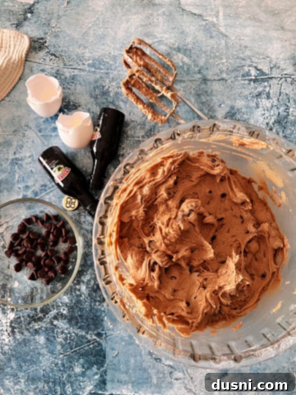 Chilled Bailey's Chocolate Chip Cookie dough ready for baking on a parchment-lined baking sheet.