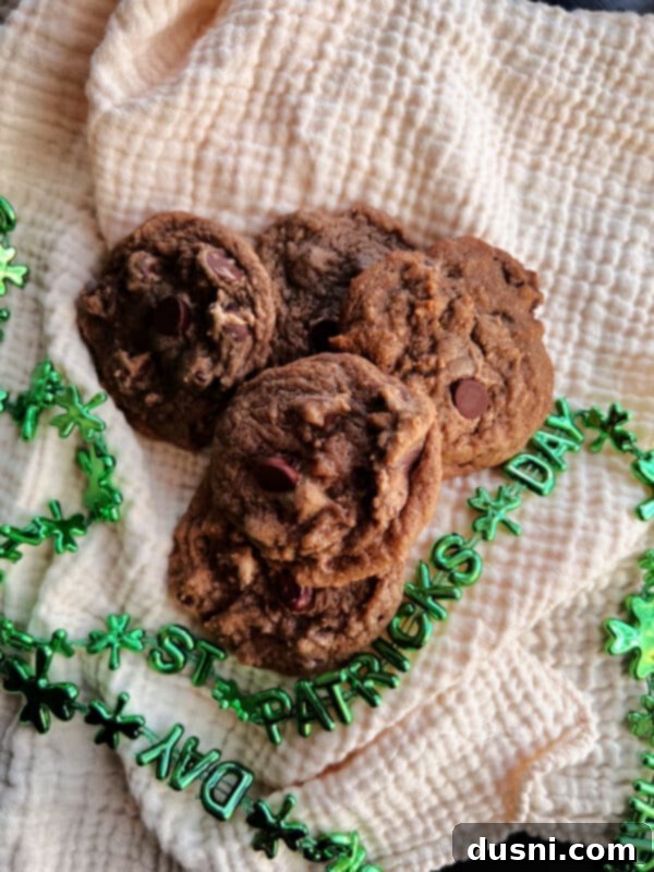 Ingredients for Bailey's Chocolate Chip Cookies laid out on a kitchen counter: flour, sugar, butter, eggs, Bailey's, and chocolate chips.