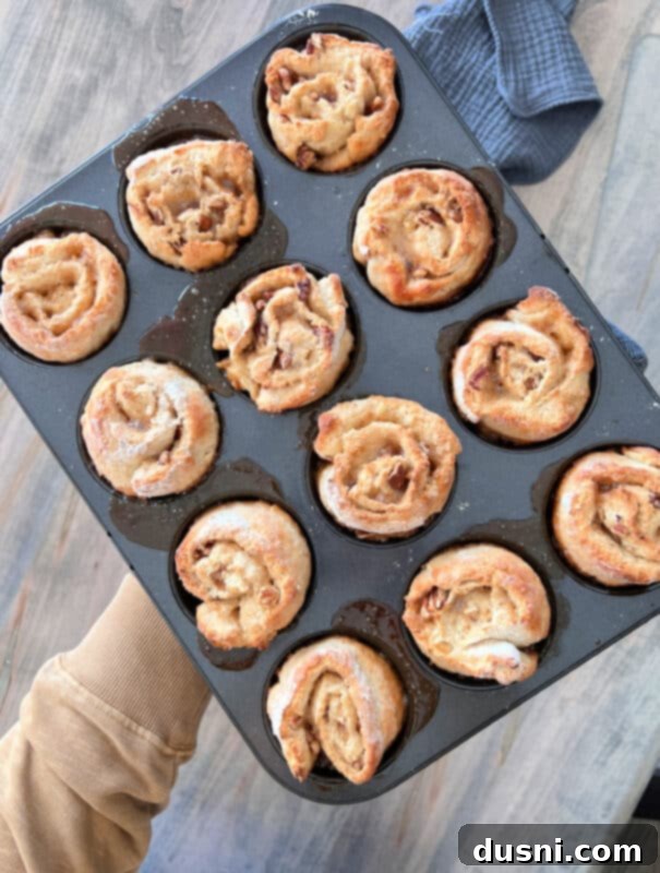 Banana Pecan Swirls 10 Step-by-step image of baked banana pecan sticky rolls, golden brown and perfectly risen in a muffin tin.