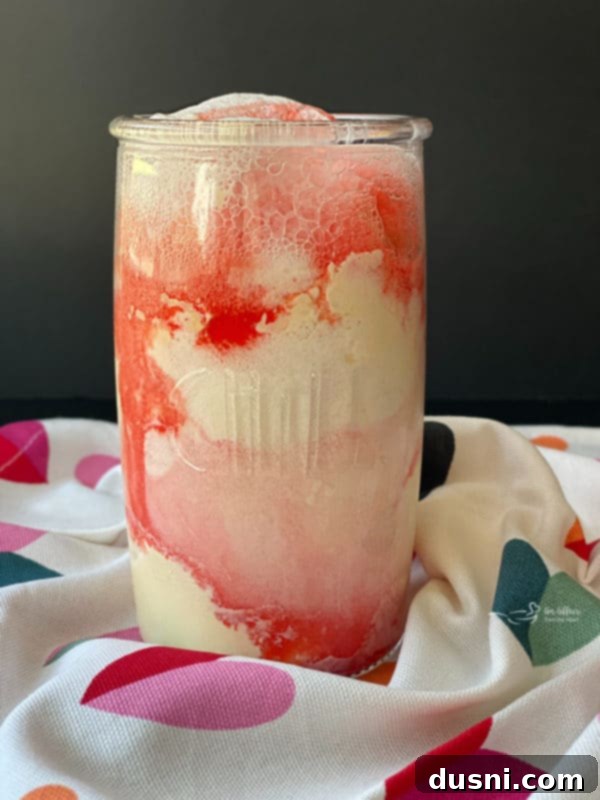 Sparkling Shirley Temple Float 5 A beautifully prepared Shirley Temple Float in a tall glass, showing the layers of ingredients