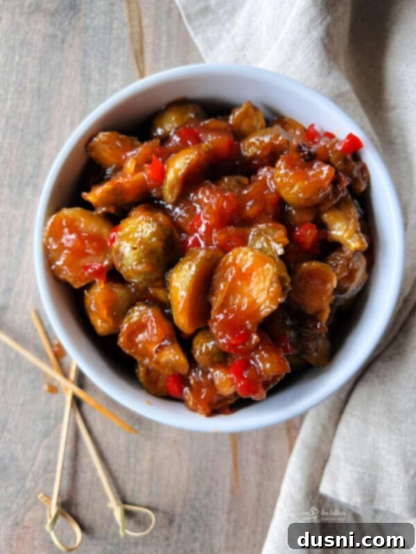 Bowl of sweet and sour Brussels sprouts with chopsticks