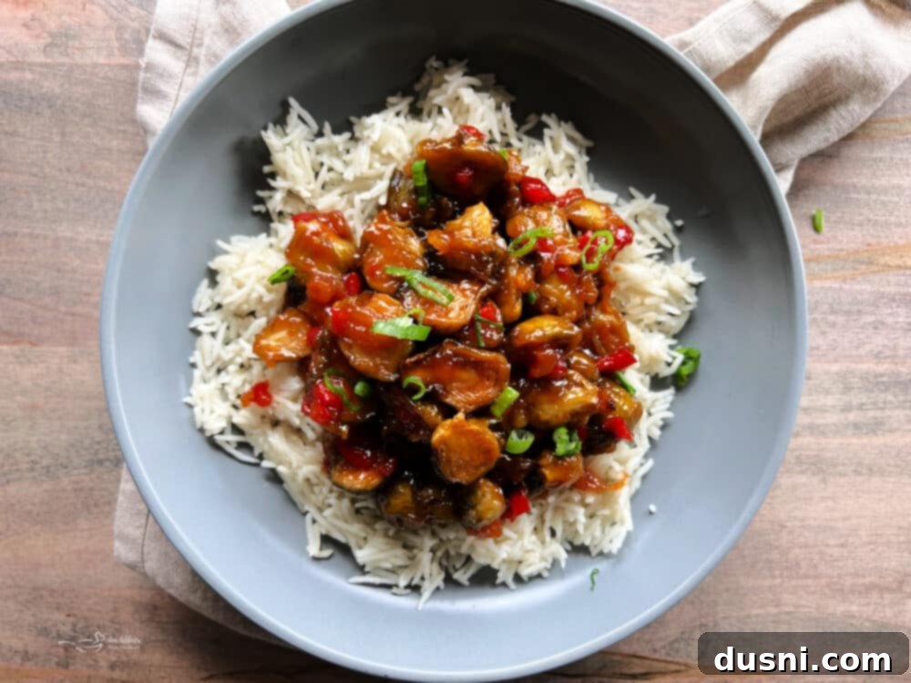 Sweet and sour sauce in a skillet, with a spoon