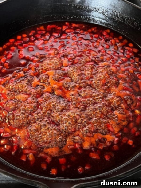 Sweet and sour sauce simmering in a skillet