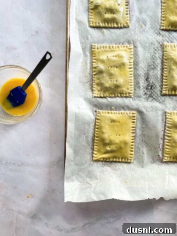 Homemade blueberry toaster strudels with egg wash before baking