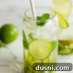 Vibrant Kiwi Mojito 15 Kiwi Mojito in a tall glass with a straw.