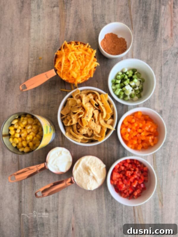 Loaded Frito Corn Salad 3 Close-up of Frito Corn Salad in a white bowl with some Frito chips on top.