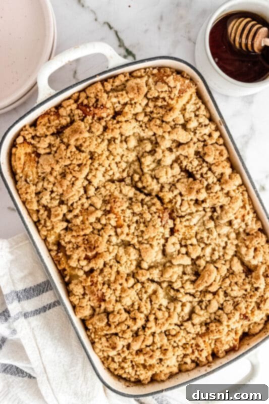 A close-up of the baked French toast casserole with a spoonful being taken.