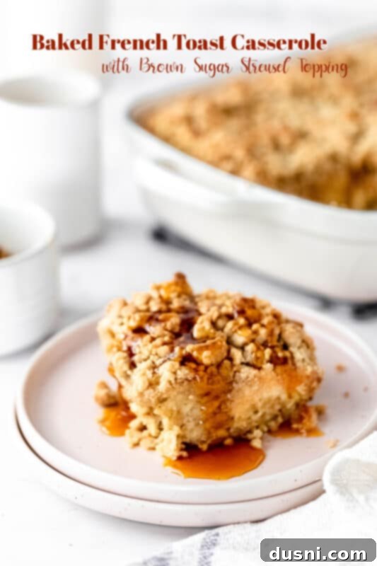A beautifully plated slice of Baked French Toast Casserole with fresh berries.