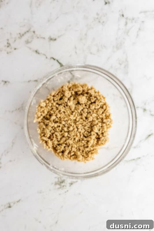 Step 4: Combining flour, brown sugar, butter, cinnamon, and nutmeg in a bowl for the streusel topping.