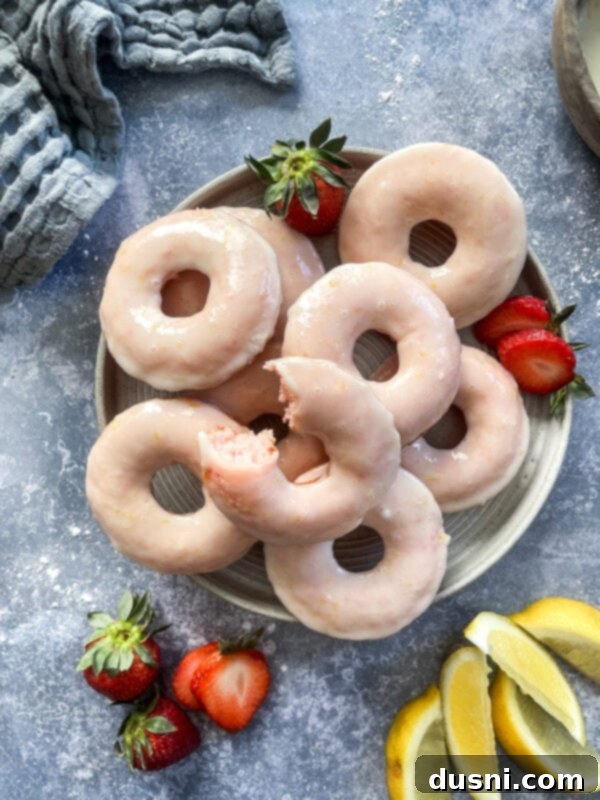 Sun-Kissed Strawberry Lemonade Donuts 2 Freshly baked strawberry lemonade donuts with lemon slices and strawberries