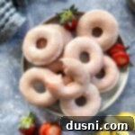Sun-Kissed Strawberry Lemonade Donuts 14 Strawberry lemonade donuts on a white plate