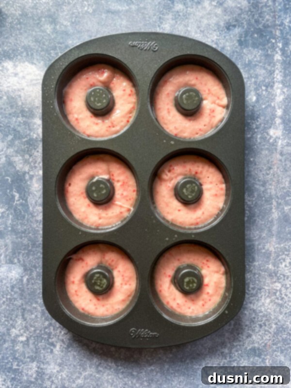 Sun-Kissed Strawberry Lemonade Donuts 6 Mixing strawberry donut batter in a glass bowl