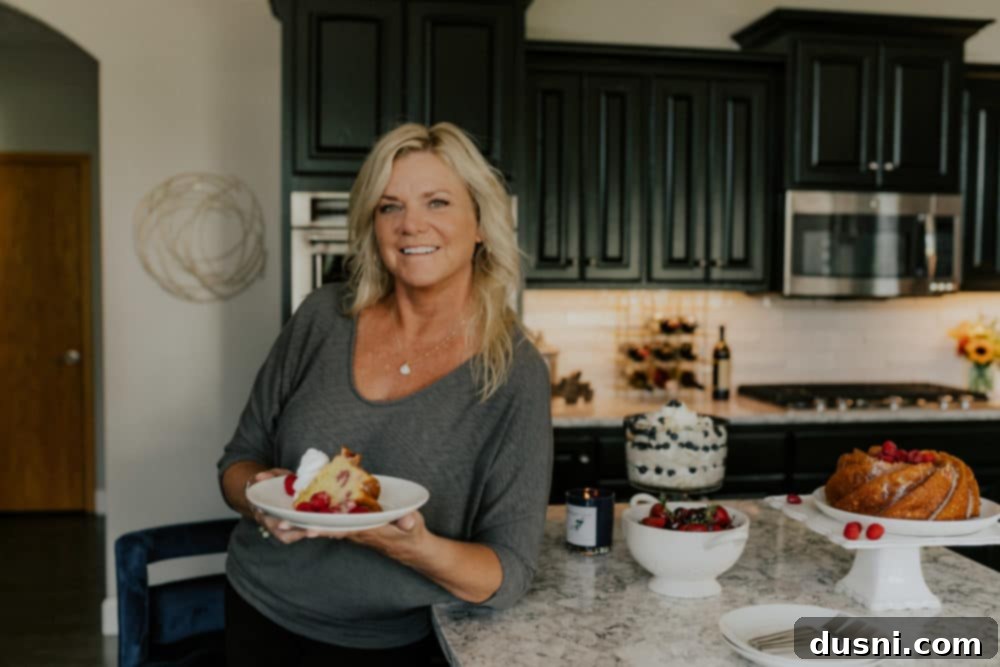 Sunshine Lemon Raspberry Bundt Cake 6 Baker decorating a bundt cake with glaze and fresh raspberries