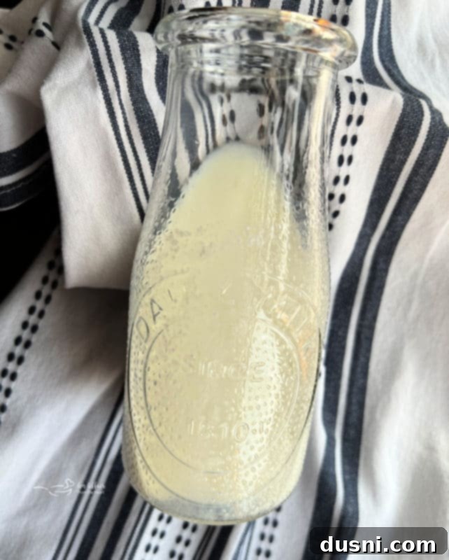 Clever Buttermilk Replacements 5 Buttermilk substitute in a measuring cup with a lemon wedge