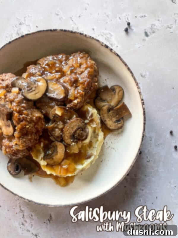 Classic Salisbury Steak with Savory Mushroom Gravy 17 Salisbury steak with mushroom gravy and mashed potatoes, close up