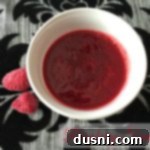Velvety Raspberry Drizzle 2 overhead of raspberry sauce in a white cup