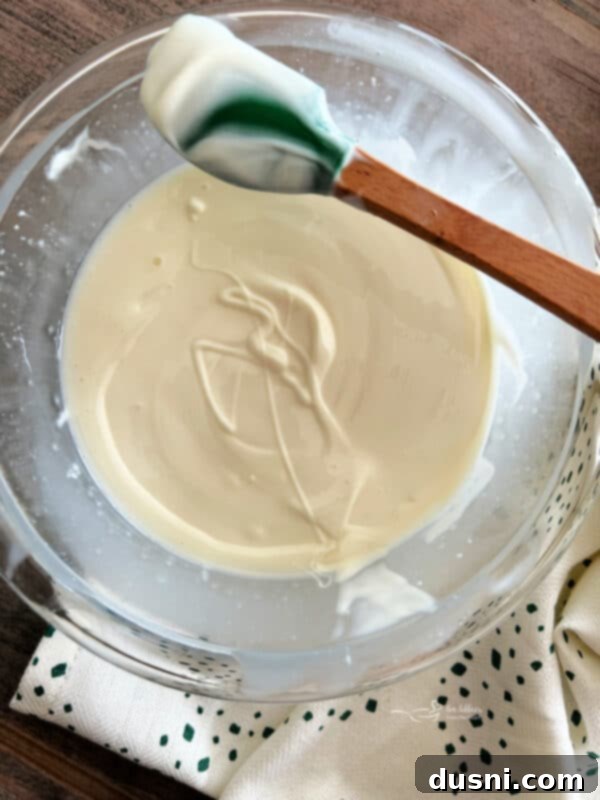 Pot of Gold Snack Blend 11 Stirring melted almond bark for a smooth consistency.