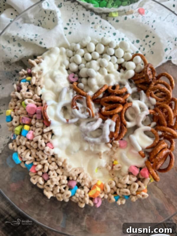 Pot of Gold Snack Blend 12 Pouring melted candy coating over the cereal mixture.