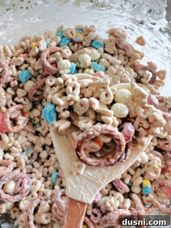 Pot of Gold Snack Blend 13 Thoroughly mixing ingredients with the candy coating.