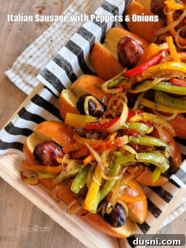 Grilled Italian Sausages with Peppers and Onions on a dark background