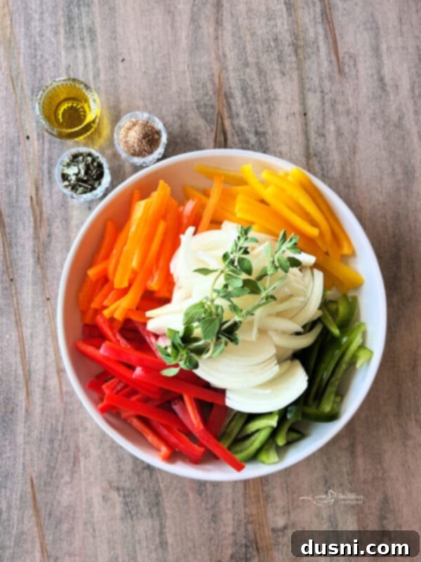 Sliced bell peppers and onion in a bowl