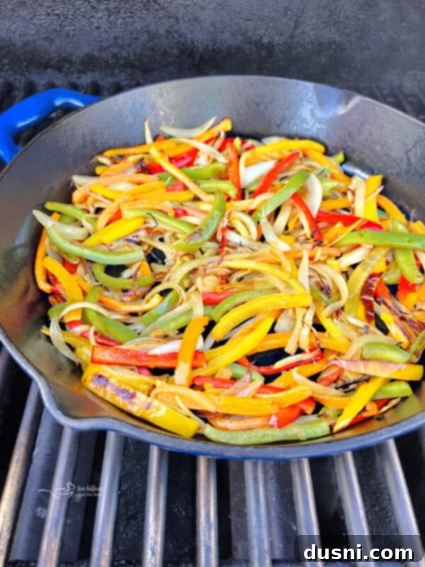 Peppers and onions seasoned in a skillet