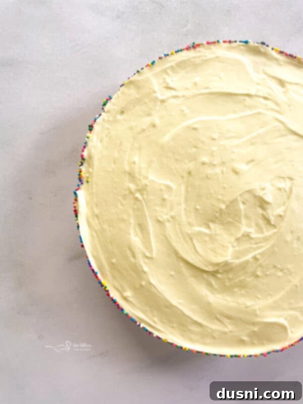 Dreamy Marshmallow Cloud Cheesecake 4 No-Bake Marshmallow Cheesecake with a spoonful taken out, showing the creamy filling and crumbly crust.