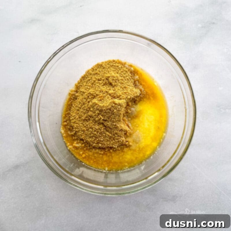 Dreamy Marshmallow Cloud Cheesecake 8 Ingredients for No-Bake Marshmallow Cheesecake being prepared, including cream cheese and marshmallow fluff.