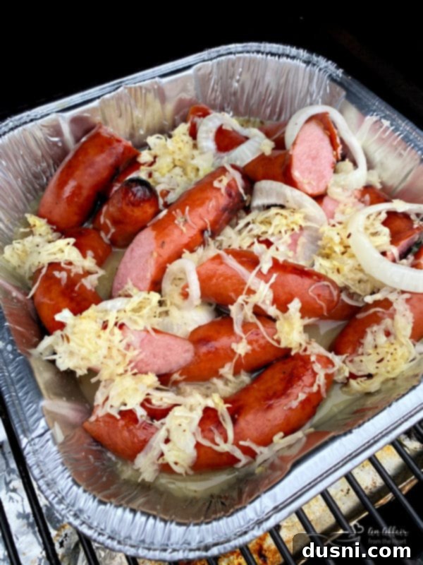 Savory Smoked Kielbasa and Sauerkraut 10 Grilled Polish Sausage and Sauerkraut in pan on grill