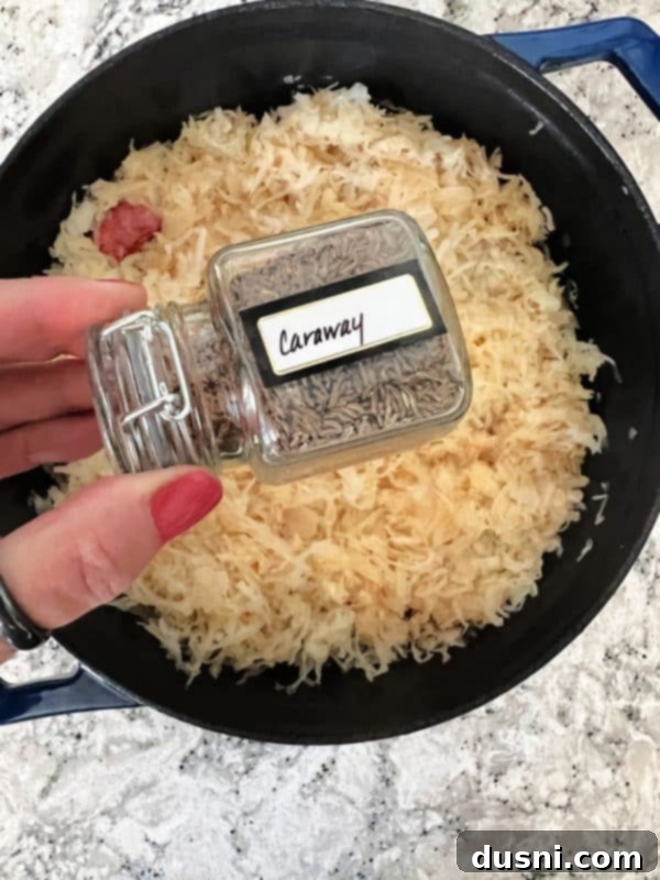 Savory Smoked Kielbasa and Sauerkraut 6 Sprinkling caraway seeds over the dish