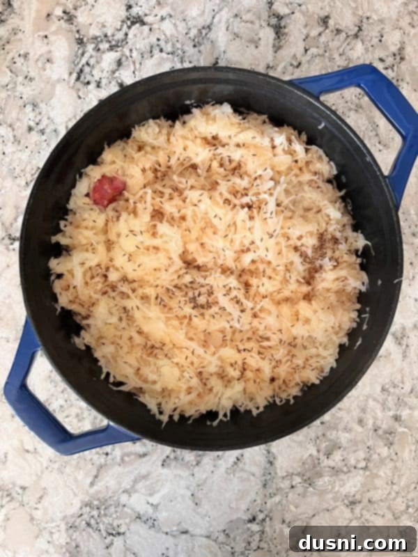Savory Smoked Kielbasa and Sauerkraut 7 Dutch oven with sausage and sauerkraut covered and baking