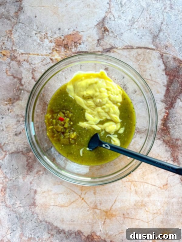 Sauce being poured over chicken in slow cooker