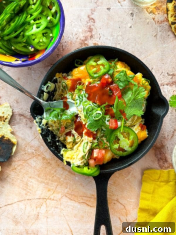 Overhead view of Slow Cooker Green Chile Chicken Enchilada Casserole in a slow cooker pot