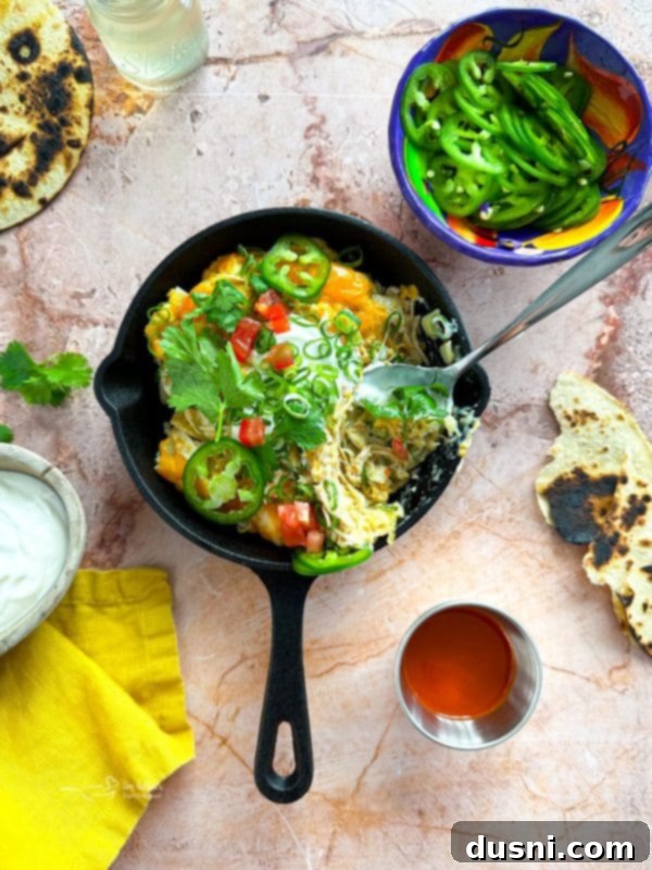 Serving dish of Slow Cooker Green Chile Chicken Enchilada Casserole